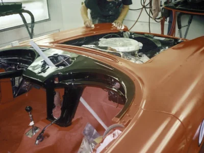 Engine bay of red 1962 Corvette with hood up during final detailing