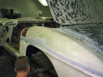 Front fender detail of 1962 Corvette body in primer with sanding marks visible
