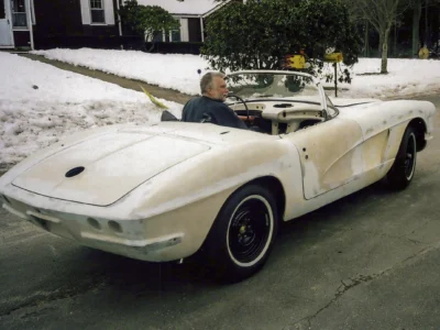 Side profile of red 1962 Corvette parked outside residence during final detailing