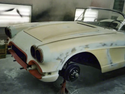 Front three-quarter of 1962 Corvette body in primer with sanding marks during paint prep