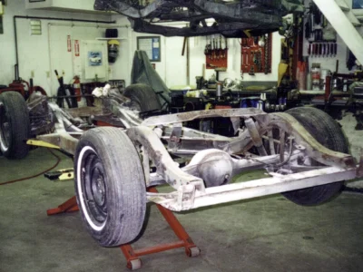 Bare 1962 Corvette rolling chassis on stands at Corvette Connection