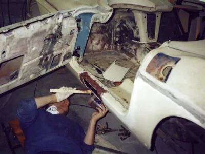 Corvette Connection technician working on 1962 Corvette body shell during bodywork