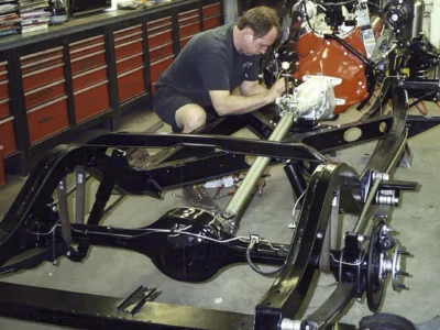 Corvette Connection technician working on 1962 Corvette rolling chassis during assembly