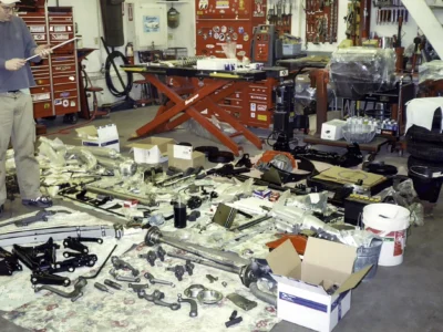 Corvette Connection technician working on 1962 Corvette rolling chassis during assembly