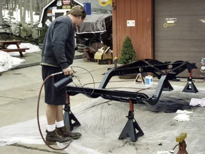 Corvette Connection technician working on 1962 Corvette rolling chassis at Corvette Connection
