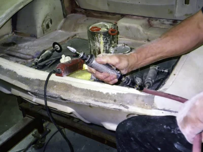 Detail of 1962 Corvette rolling chassis exhaust and underbody during outdoor inspection