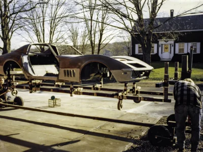 1968 Corvette body in bare fiberglass and primer showing filler work during restoration