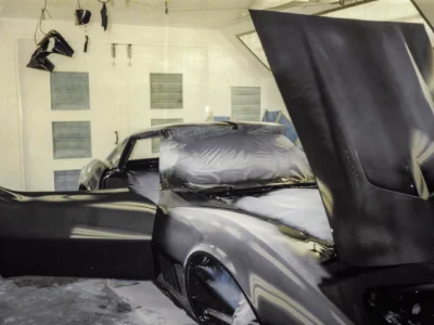 1968 Corvette Stingray in black base coat with masking still on in paint booth
