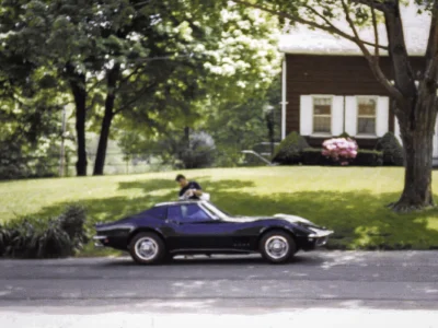 Finished 1968 Corvette Stingray in black on grass side view
