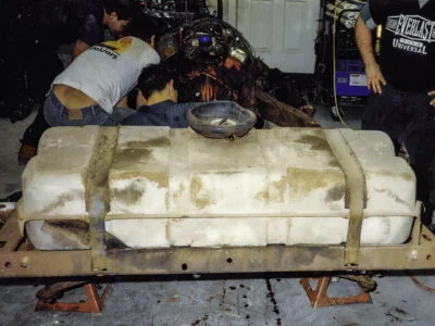 1968 Corvette fiberglass body panel removed showing bare structure during teardown