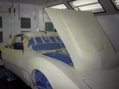 1968 Corvette Stingray hood inner panel with blue masking tape during paint prep