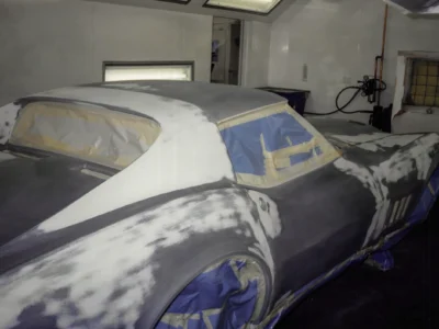 1968 Corvette Stingray front end masked with blue tape before final black paint