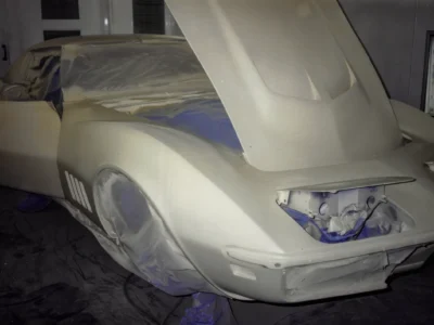 1968 Corvette Stingray hood and fender in primer ready for paint in paint booth