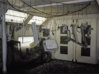 1968 Corvette fiberglass body panels hanging in paint booth during restoration