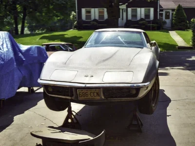 White 1968 Corvette parked outside before restoration work