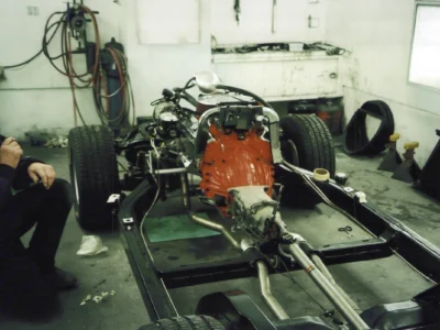 Red small-block engine installed on a 1968 Corvette chassis.