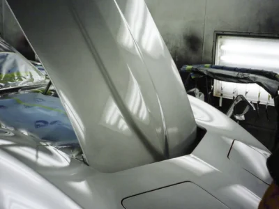 1968 Corvette with hood raised, showing the body and engine bay during restoration