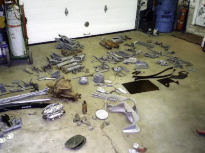 1968 Corvette restoration parts laid out on the shop floor for cleaning and inspection.