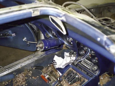 1968 Corvette interior with blue dashboard and exposed floor during restoration.