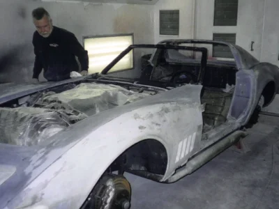 1969 Corvette body in white primer inside the paint booth.
