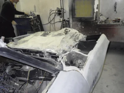 1969 Corvette rear body and deck area in primer during paint preparation.