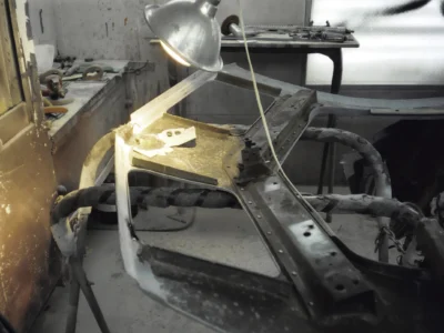 1969 Corvette windshield frame and rear deck area being prepared in the paint booth.