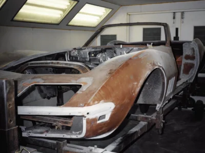 1969 Corvette body in primer showing front end and hood during body work at Corvette Connection