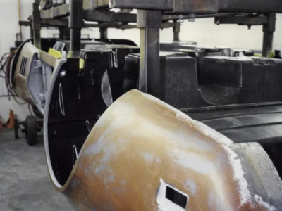 1969 Corvette front fender in primer showing smooth body lines during restoration