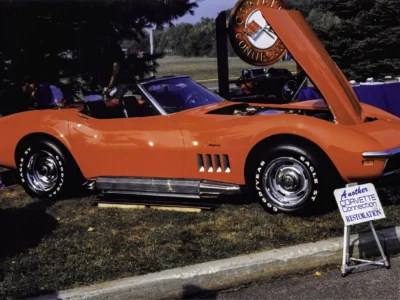 Completed 1969 Corvette Stingray convertible in red with hood up at car show