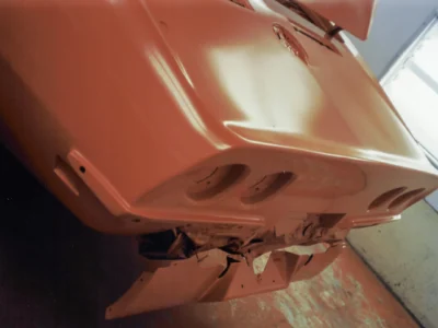 1969 Corvette Stingray hood detail showing side vents in fresh red paint