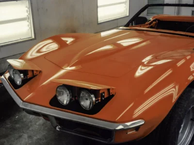 1969 Corvette Stingray front end in fresh red paint showing headlights and fender detail