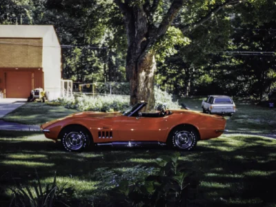 Restored 1969 Corvette Stingray convertible in red side profile outdoor beauty shot