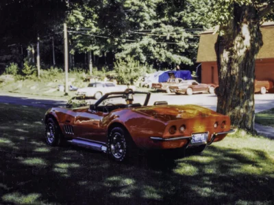Completed 1969 Corvette Stingray convertible in red on grass beauty shot at Corvette Connection in Bolton CT
