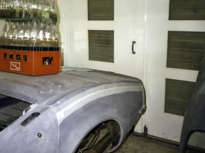 1969 Corvette front fender in gray primer during bodywork.