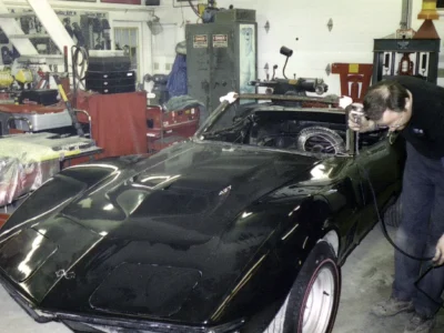 Black 1969 Corvette convertible inside the shop during early restoration.