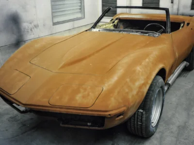 1969 Corvette Stingray convertible in orange primer rear three-quarter view at Corvette Connection