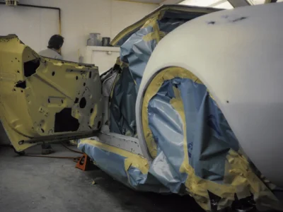 1969 Corvette Stingray body masked with tape and paper during paint prep at Corvette Connection