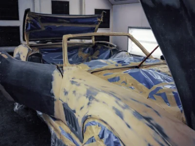 1969 Corvette Stingray convertible body masked with blue tape and plastic for final paint at Corvette Connection