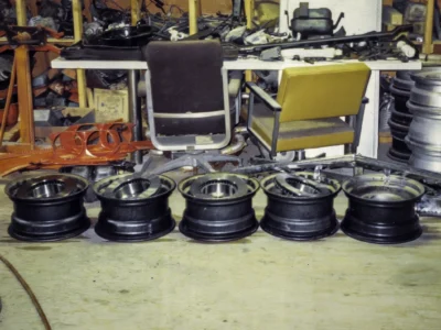 1969 Corvette brake drums and wheels laid out during disassembly at Corvette Connection