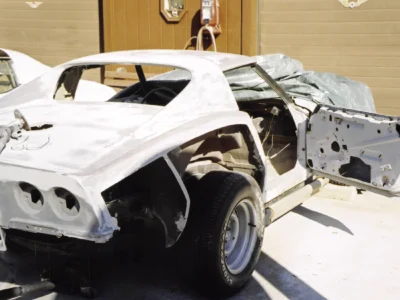 Rear view of 1969 Corvette body shell in white primer outside Corvette Connection.