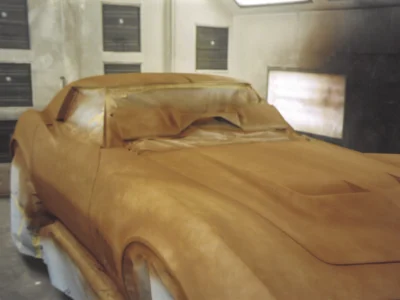 1969 Corvette body in red primer during early paint preparation