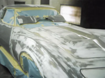 1969 Corvette body in primer with sanding marks during paint preparation.