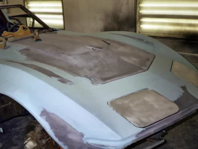 Close-up of 1970 Corvette hood showing sanding and filler work.