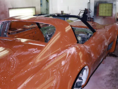 Freshly painted red 1970 Corvette body inside the paint booth.