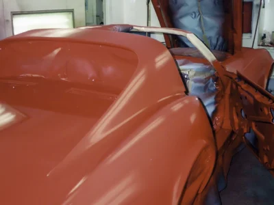 Close-up of fresh red paint on a 1970 Corvette rear quarter panel.