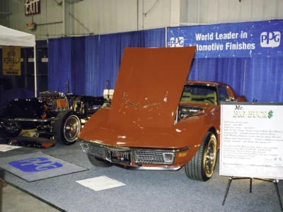 Red 1970 Corvette displayed indoors with hood raised at a car event.Red 1970 Corvette displayed indoors with hood raised at a car event.