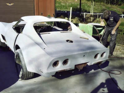 1970 Corvette rear body section in white primer outside the shop.