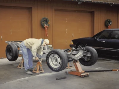 Technician working on McBurnie Daytona Spyder suspension at Corvette Connection in Bolton CT
