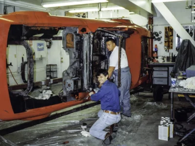 Technician working on McBurnie Daytona Spyder body in shop at Corvette Connection