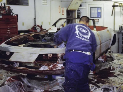 Technician working on McBurnie Daytona Spyder front end during body assembly at Corvette Connection